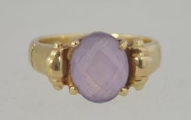 A 9ct gold hallmarked cloudy amethyst ladies dress ring having a bucke style ring.