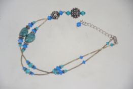 A silver crystal and sodalite necklace being marked 925.