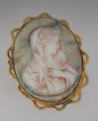 A large 19th century cameo brooch with gold plated lattice mount and pin,