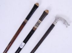 SWORD STICKS: A Collection of three 20th century sword walking sticks.