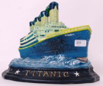 TITANIC: A 20th century cast iron doorstop in the form of White Star Line's Titanic. Hand painted.