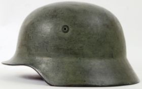 NAZI HELMET: An original WWII Second World War era NAzi Third Reich uniform helmet, in green.