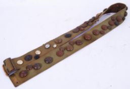 BUTTONS: A 'hate belt' uniform belt decorated with various regimental buttons (mostly British).