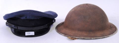 HEADWEAR: Two vintage military hats - including a second world war era tin helmet and an RAF style