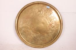 A Keswick brass wall charger by W H Mawson,
