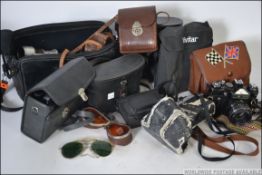 Mixed lot of camera and binoculars , to include brands such as Zenit , Canon ,