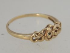 A hallmarked 9ct gold ring with bow and heart motif . Hallmarked Biringham. Size P.