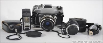 A vintage 1960's EXA 500 35mm camera by Ihagee of Dresden to include a Carl Zeiss lens, flash head,