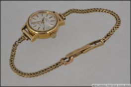 A ladies Rotary cocktail dress watch set to a 9ct gold hallmarked snake linked bracelet.
