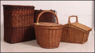 2 20th century picnic hampers with hinged tops together with 2 vintage whicker weaved baskets.
