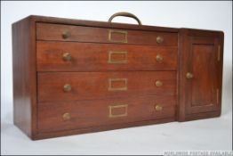 A mid 20th century engineers tool box / case having a run of four drawers next to a single door