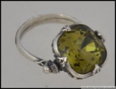 An early 20th century silver and citrine revolving dress ring. The cut stone with swivel mount.
