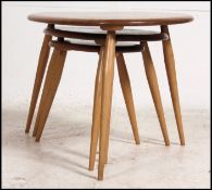 An Ercol beech and elm retro pebble nest of tables.