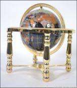 A small table top semi-precious stone inlaid terrestrial globe of the world,
