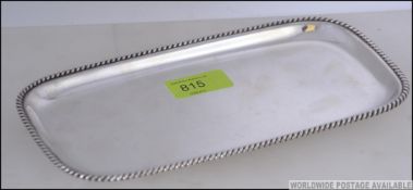 A sterling silver salver marked 925 of rectangular form with gadrooned edges.