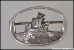 A silver hallmarked brooch of sailing ship with rigging up on open sea bearing a Chester assay mark