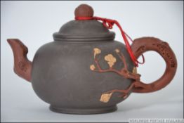 A 20th century Chinese yi xing terracotta teapot having a handle and spout in the form of a tree
