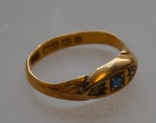 A hallmarked 22ct gold antique sapphire and diamond ring in near gypsy mount.
