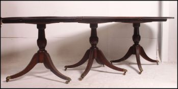 A good quality large early 20th century Regency pedestal dining table in mahogany with ebonised