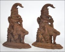 2 Victorian 19th century cast iron doorstops of Mr Punch, each raised on plinth bases.