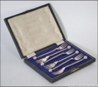 A cased set of early 20th century cocktail twizzle stem forks complete in the original presentation
