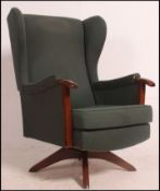 A good original 1960's Parker Knoll wing back armchair on swivel base.