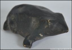 A believed 19th century Inuit / tribal carved brass figurine of a frog of very rustic form.