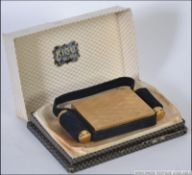 A cased 1950's Kigu of London cigarette case and compact companion set with suede upholstered case