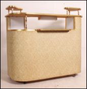 A fabulous 1960's retro vinyl upholstered cocktail / drinks bar having raised serving platforms