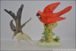 A Crown Staffordshire porcelain figurine of a Red Cardinal bird designed and modelled by J.T.