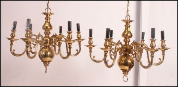 A pair of 19th century Dutch style brass six light chandeliers with globular turned stems from