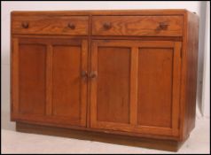 A 1930's Heals style oak sideboard dresser.