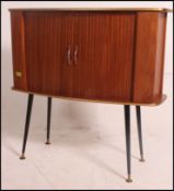 A vintage 1950's retro tambour colour tone fronted drinks cabinet raised on atomic style ebonised