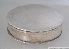 A silver hallmarked ladies dressing table lidded dish of circular form having partially rubbed