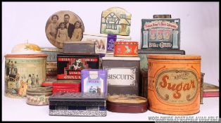 A collection of vintage tins from the 20th century to include large Sugar tin, biscuit tins,