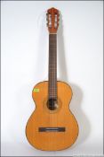 An acoustic six string Spanish style guitar bearing makers label to centre for Rosenetta