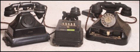 A vintage early 20th century Bakelite telephone system to include twin handsets and an exchange