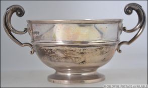 A silver hallmarked twin handled dish with terraced foot,