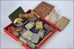 A dealers lot to include silver plated vesta's, aide du memoirs, mesh purses, carved pipe,