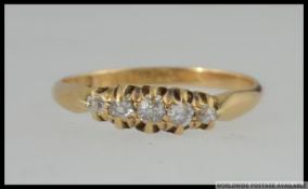 An Edwardian 18ct gold hallmarked diamond ring set with 5 old cut diamonds in a gypsy setting