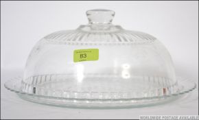 A 20th century glass cloche with finial top complete with glass base tray. Measures: 31cms wide.