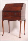 A Queen Anne 1950's mahogany ladies writing bureau raised on cabriole legs with pad feet having