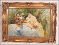 A large 20th century oil on canvas painting of a lady in summer scene set within a gilt frame.
