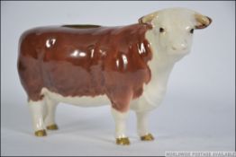 A Beswick figure of a Hereford Cow entitled Ch of Champions having printed marks to base.