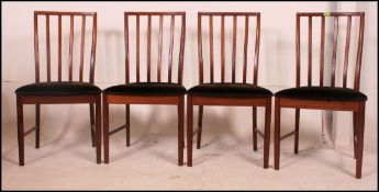 A collection of four Danish influenced G Plan / Macintosh rail back teak dining chairs having