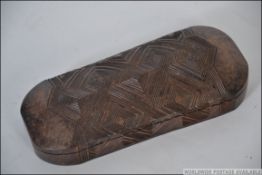A 20th century Polynesian / Fijian tribal carved hard wood lidded case having continuous geometric