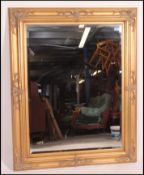 A good quality large antique style wall mirror of decorative form dating to the 20th century being