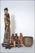 A collection of Asiatic items dating from the 20th century to include wooden carvings, seals,