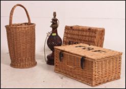 2 vintage whicker hampers together with an early 20th century stick stand / oyster basket and a