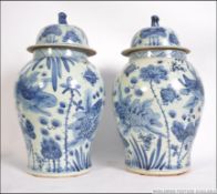 A large pair of Chinese blue and white Kang-xi oversized ginger jars complete with lids having